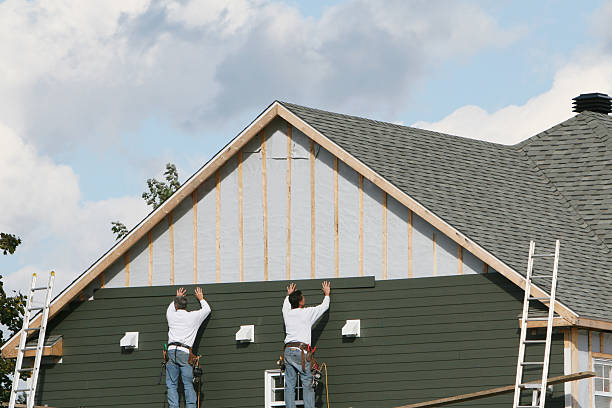 Professional Storm Damage Siding Repair technician working in Laura, OH